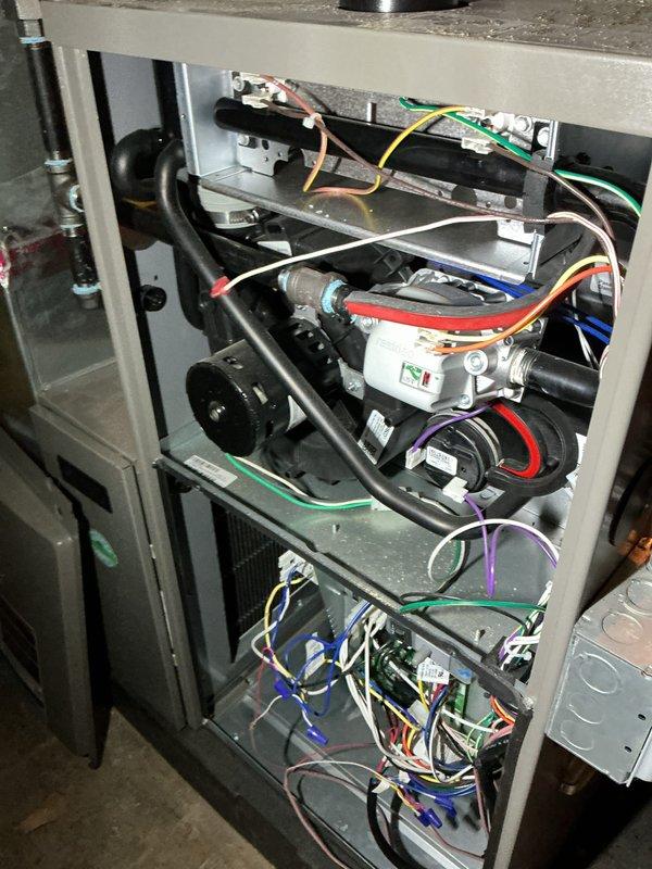 # HVAC Maintenance - AHC Service Report

Completed annual heating maintenance and comprehensive tune-up on residential furnace system as part of Air Care Membership complimentary service. Unit was reported to be operating properly at time of service call, with maintenance performed during scheduled 10:00 AM – 2:00 PM window.

## Service Performed

Conducted thorough inspection and maintenance of furnace system with 0 years of service life. Removed access panels to gain full access to internal components for detailed examination. Performed visual inspection of all major system components including heat exchanger, blower motor assembly, ignition system, and burner assembly.

Inspected electrical connections throughout the unit, including terminal blocks, control board wiring, and safety circuit connections. Verified proper wire routing and connection integrity across multiple colored conductors including line voltage and low voltage wiring. Examined motor assemblies and associated electr