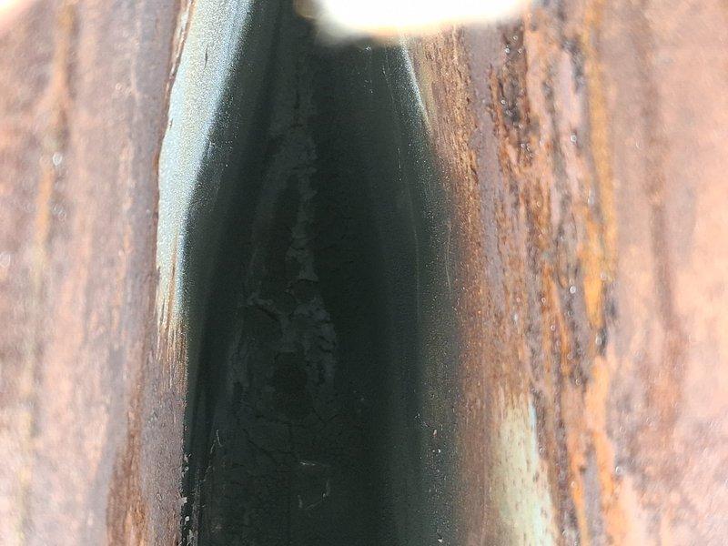# HVAC Maintenance - AHM Service Report

Completed routine annual furnace maintenance as part of preventative maintenance membership program. Performed comprehensive tune-up on 0-year-old furnace system including standard inspection, cleaning, and operational testing protocols.

During visual inspection, identified severe rust and corrosion on heat exchanger components. Metal surfaces displayed extensive deterioration with reddish-brown oxidation and textured scaling throughout, indicating prolonged moisture exposure. U-shaped heat exchanger channels showed significant rust penetration with darker interior surfaces and compromised structural integrity. Sharp metal edges exhibited less corrosion but surrounding areas demonstrated pervasive deterioration requiring immediate attention.

Secondary inspection revealed additional corrosion evidence on furnace cabinet and internal mounting surfaces. Vertical rust streaking patterns observed on cabinet panels and wooden structural supports, co