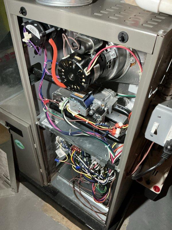 # HVAC Maintenance - AHM Service Report

Completed annual furnace maintenance as part of active care membership coverage. Performed comprehensive system inspection with access panel removal to evaluate all internal components including blower motor assembly, gas valve system, and control board connections. 

Conducted visual inspection of electrical connections throughout the unit, verifying integrity of multi-colored wire harnesses connecting blower motor, gas valve, and control board. Examined blower motor operation and verified proper mounting and electrical connections including red wire terminals. Inspected gas valve assembly and associated wiring connections in various colors for secure attachment and proper routing.

Evaluated control board functionality and wire terminations, checking all colored wire connections (yellow, red, blue, purple, white, black) for tightness and proper seating. Verified ventilation pathways and cabinet integrity. Inspected ductwork connections at uppe