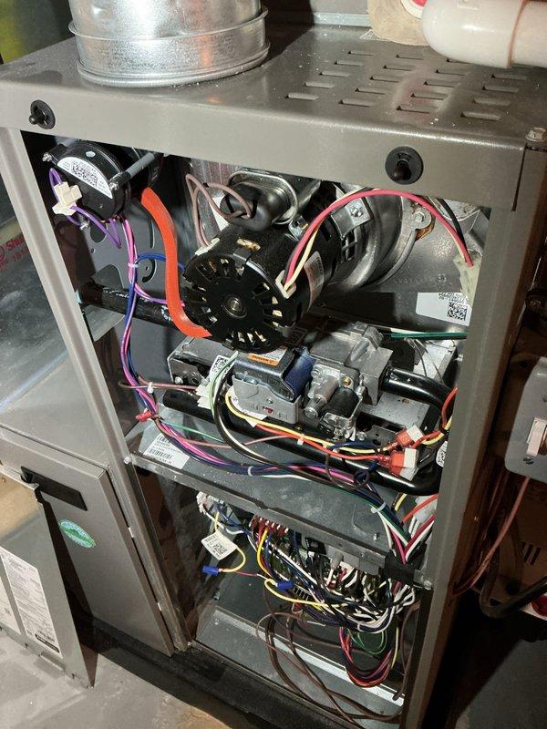 # HVAC Maintenance - AHM Service Report

Completed annual furnace maintenance as part of active care membership coverage. Performed comprehensive system inspection with access panel removal to evaluate all internal components including blower motor assembly, gas valve system, and control board connections. 

Conducted visual inspection of electrical connections throughout the unit, verifying integrity of multi-colored wire harnesses connecting blower motor, gas valve, and control board. Examined blower motor operation and verified proper mounting and electrical connections including red wire terminals. Inspected gas valve assembly and associated wiring connections in various colors for secure attachment and proper routing.

Evaluated control board functionality and wire terminations, checking all colored wire connections (yellow, red, blue, purple, white, black) for tightness and proper seating. Verified ventilation pathways and cabinet integrity. Inspected ductwork connections at uppe