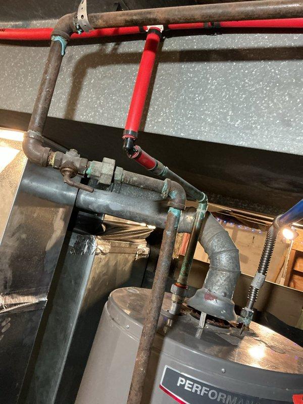 # Service Report: Tanked Water Heater Diagnostic

Responded to service call for a Performa brand tanked water heater with pilot light failure. Performed diagnostic evaluation of the unit's gas control system, thermocouple, and ignition components. Inspected the water heater installation including copper supply piping, temperature and pressure relief valve connections, and gas line configuration. Assessed the overall condition of the tank, control assembly with red gas valve handle, and related plumbing connections. 

Diagnosed pilot light assembly malfunction preventing sustained ignition. Customer declined repair and opted for diagnostic service only with no parts or labor warranty.