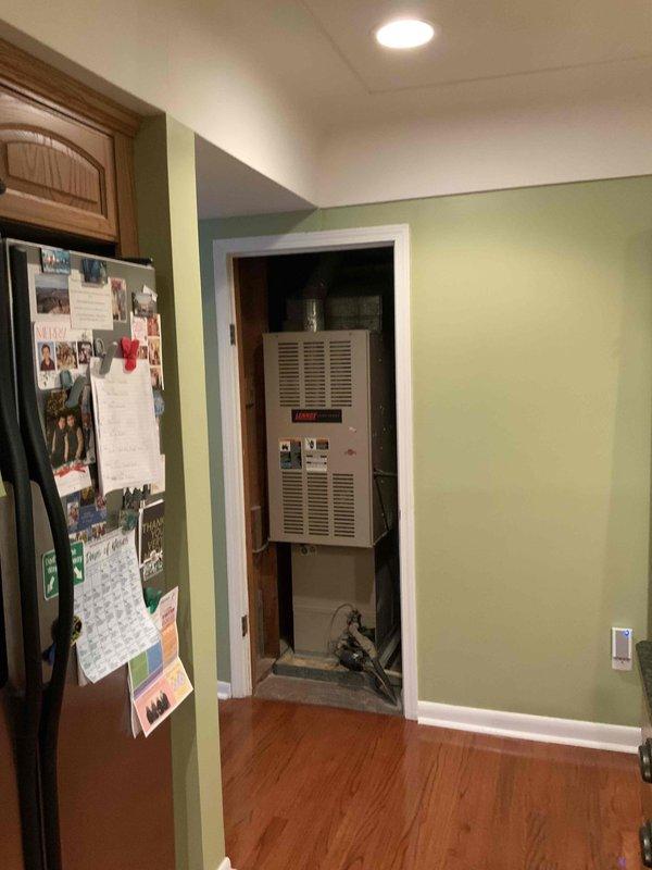 Completed on-site evaluation for replacement estimate of existing Bryant downflow gas forced air furnace system located in utility closet adjacent to kitchen area. Assessed current equipment configuration, ductwork connections, venting requirements, and available installation space. Documented existing HVAC setup and tankless water heater installation with photographs to provide accurate replacement system specifications and ensure proper equipment sizing for customer's multiple estimate comparison.