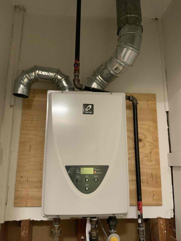 Completed on-site evaluation for replacement estimate of existing Bryant downflow gas forced air furnace system located in utility closet adjacent to kitchen area. Assessed current equipment configuration, ductwork connections, venting requirements, and available installation space. Documented existing HVAC setup and tankless water heater installation with photographs to provide accurate replacement system specifications and ensure proper equipment sizing for customer's multiple estimate comparison.