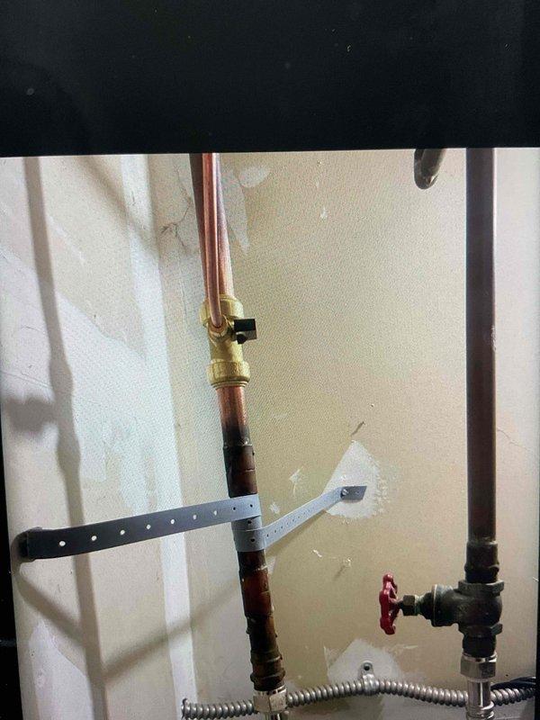 # HVAC Install Warranty Service Summary

Completed installation of 90,000 BTU furnace and 3.5-ton rear-discharge air conditioning system per approved specifications. Installation included integration of humidifier unit with proper water supply connection and reconnection of existing system components. All required mechanical and electrical permits were secured prior to installation. Plumbing connections were established using copper supply lines with appropriate shut-off valves and flexible metal connectors for humidifier feed line. System was properly mounted, secured, and tested for operational functionality. Installation photos document completed plumbing connections, including brass valves, copper piping, and flexible supply lines mounted to wall with appropriate securing hardware. A follow-up service appointment has been scheduled to inspect for potential water hammer noise from the humidifier feed line and install water hammer arrestor if needed to eliminate pressure surge issues