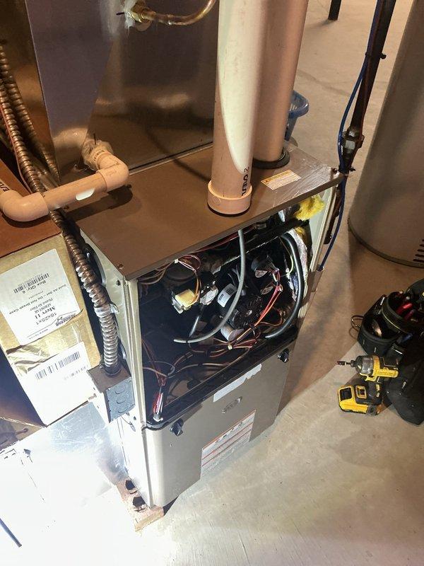 # HVAC Maintenance - AHM Service Summary

Completed scheduled Air Care Heating recurring maintenance service on residential furnace system. Performed comprehensive inspection of internal components with access panel removed, examining wiring harness, electrical connections, and gas valve assembly. Verified proper operation of blower motor, heat exchanger, and exhaust venting system including flue pipe connections. Inspected condensate drainage system and PVC piping for proper function. All components found to be operating within normal parameters with no deficiencies noted at time of service.