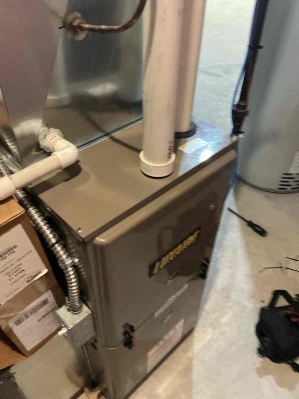 # HVAC Maintenance - AHM Service Summary

Completed scheduled Air Care Heating recurring maintenance service on residential furnace system. Performed comprehensive inspection of internal components with access panel removed, examining wiring harness, electrical connections, and gas valve assembly. Verified proper operation of blower motor, heat exchanger, and exhaust venting system including flue pipe connections. Inspected condensate drainage system and PVC piping for proper function. All components found to be operating within normal parameters with no deficiencies noted at time of service.