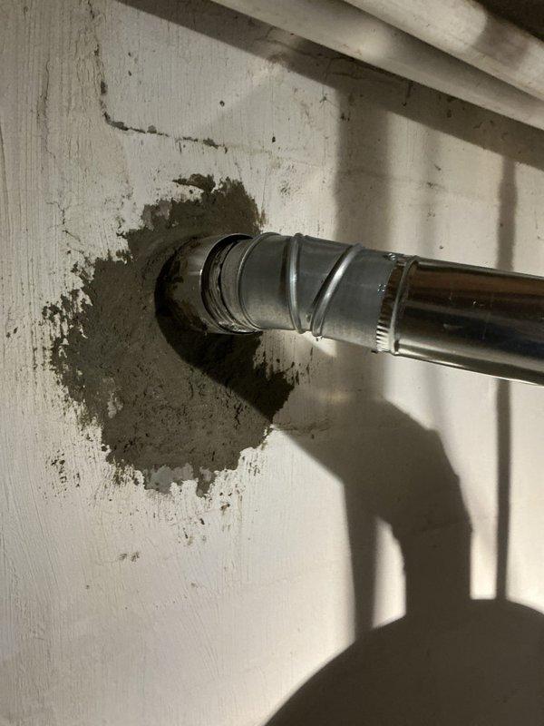 # HVAC Install - Call Back Summary

Returned to address chimney liner installation follow-up. Inspected metallic duct penetration through interior wall showing deterioration and paint damage around pipe entry point. Verified proper installation and sealing of aluminum/galvanized ductwork connections. Examined water heater mechanical assembly including Honeywell 24V control unit with proper electrical connections, copper piping with brass fittings, and blue-handled valve. Confirmed all control wiring, conduit, and safety labels in place and functioning correctly.