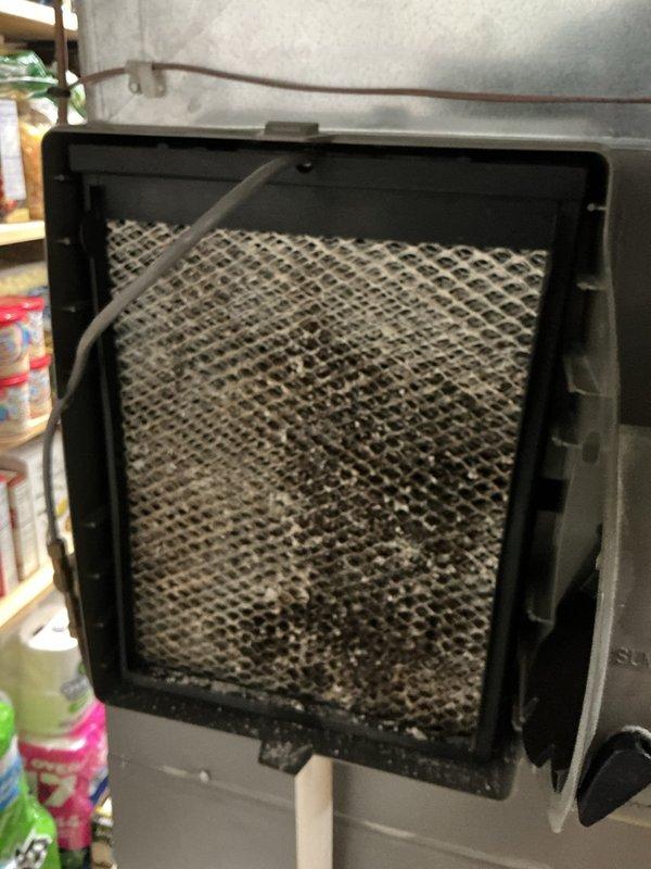 # HVAC Maintenance - ACM Service Report

Performed comprehensive annual maintenance on a 10-year-old air conditioning system. Conducted complete system inspection and tune-up procedures to ensure optimal performance and efficiency for the cooling season.

## Work Performed

Inspected and evaluated all major system components including condenser unit, evaporator coil, and air handling equipment. Removed and examined air filter, which showed heavy accumulation of dust, dirt, and debris throughout the mesh surface, indicating extended use period. The filter media displayed significant clogging with grayish-brown particulate matter covering most of the surface area, restricting proper airflow.

Measured system temperatures using digital thermometer to verify proper refrigerant charge and heat transfer. Recorded supply air temperature reading of 50.3°F at the ductwork, confirming adequate cooling performance and proper system operation. Checked refrigerant lines for proper insulation and co