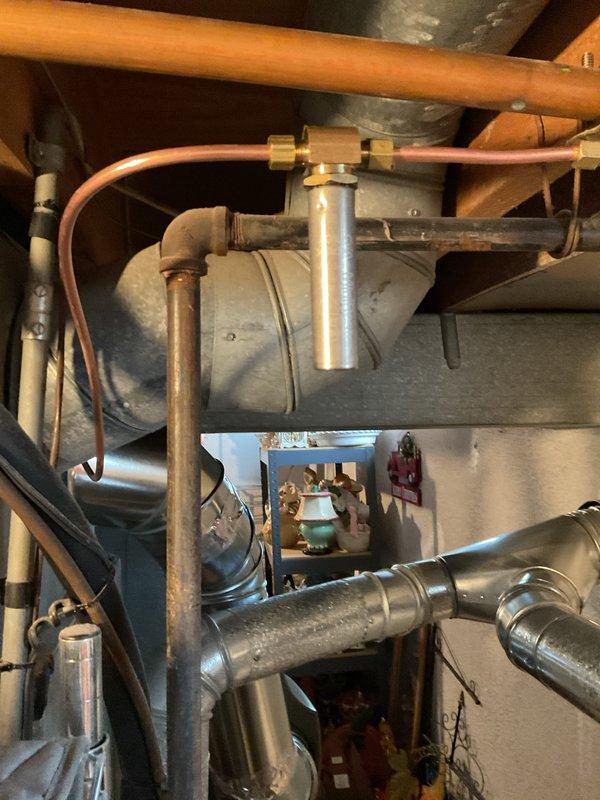 # HVAC Install - IAQ Service Summary

Successfully installed a 17G whole-home humidifier system in the basement mechanical room as part of an indoor air quality upgrade. The installation included mounting the humidifier unit to the existing ductwork, establishing water supply connections using copper tubing with brass compression fittings, and integrating the system with the HVAC infrastructure. All components were properly secured to structural framing, with appropriate drainage provisions installed to ensure safe operation.

## Work Performed

Installed the 17G humidifier unit in the utility area adjacent to the main HVAC system. Ran new copper water supply lines from the existing plumbing infrastructure, utilizing brass fittings for secure connections to the humidifier inlet. Mounted the humidifier assembly vertically on the supply or return duct plenum, ensuring proper orientation for optimal water distribution across the evaporator pad. Installed necessary electrical connections t