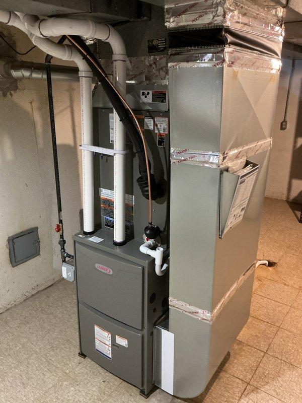 # HVAC Install - Complete System

Successfully completed installation of a complete residential HVAC system consisting of a Lennox 90,000 BTU furnace and 3-ton air conditioning unit with rear discharge configuration. Obtained and processed mechanical and electrical permits prior to installation as required by code.

Positioned and secured the new Lennox furnace unit in the basement mechanical room, establishing proper clearances and ensuring level placement on existing flooring. Connected all necessary PVC venting components for combustion air intake and exhaust, routing pipes according to manufacturer specifications and local code requirements. Completed electrical connections from the existing panel to the furnace, ensuring proper voltage supply and circuit protection.

Installed the air handler assembly with reflective foil-backed insulation wrap to minimize heat loss and condensation. Fabricated and connected ductwork transitions using corrugated metal sections, securing all connec