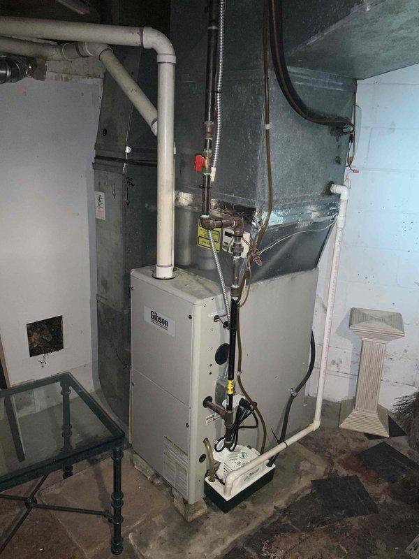 # HVAC Estimate - Full System

Completed comprehensive system evaluation for residential forced-air HVAC installation. Inspected existing 16-year-old air conditioning unit with confirmed major refrigerant leak requiring full replacement, and assessed 15-year-old furnace currently operational per customer request. Documented equipment specifications, clearances, and existing installation configuration including white metal furnace housing, ductwork transitions, PVC condensate drainage, electrical connections, and control wiring. Photographed manufacturer data plates, combustible material clearance labels, interior components including capacitor and refrigerant lines, and overall mechanical room layout in unfinished basement setting. Provided detailed quote for air conditioning system replacement while noting furnace remains functional and does not require immediate replacement at this time. Customer seeking replacement within one month timeframe.