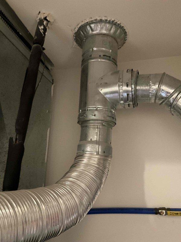 # HVAC System Replacement Estimate

Conducted on-site evaluation of 21-year-old furnace and air conditioning system requiring complete replacement due to age and end of service life. Documented existing ductwork configuration, plenum connections, and flexible duct routing to assess compatibility with new equipment installation. Photographed current HVAC components including ceiling-mounted supply plenum with access panel, flexible aluminum ductwork connections, rigid metal duct transitions, and associated PVC condensate drainage piping to establish baseline conditions and plan replacement specifications.