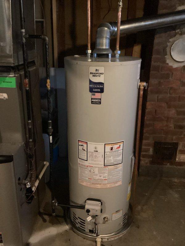 Installed a 50-gallon Bradford White tanked water heater in basement utility area, including all necessary hot and cold water connections via copper piping and proper venting. Obtained mechanical permit prior to installation and completed reconnection of all plumbing lines to restore full hot water service to the residence.