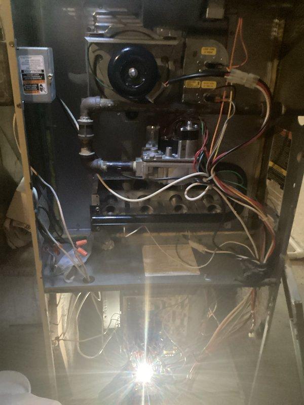 Completed annual HVAC maintenance on residential gas furnace system. Performed comprehensive inspection of blower motor assembly, gas valve components, burner assembly, heat exchanger, refrigerant lines, and electrical connections. Customer reported carbon monoxide alarm activation prior to service call but declined to schedule separate diagnostic appointment; alarm had reset and customer requested to proceed with scheduled maintenance only. All accessible components inspected and documented with interior photographs showing blower motor, control assemblies, wiring harnesses, and copper refrigerant tubing in satisfactory operating condition at time of service.
