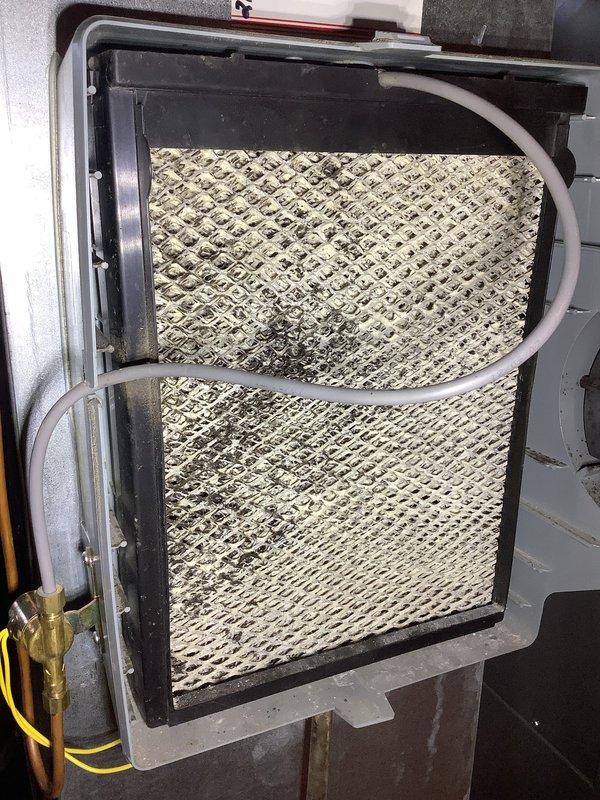 # HVAC Maintenance - AHC Service Summary

Completed comprehensive air handler and heating system maintenance as part of recurring Air Care service program. Performed thorough inspection of evaporator coil assembly, noting moderate dust and debris accumulation on diamond-pattern mesh filter requiring attention. Examined air filtration system housed within hinged access panel, checked refrigerant line connections and condensate drain routing for proper operation.

Conducted detailed inspection of gas furnace internal components including burner assembly with pilot indicators, gas valve controls, and ignition system. Verified electrical connections throughout unit, inspecting multiple wire runs and control circuits. Examined gas control valve assembly with associated safety components and plastic fittings for secure connections and proper operation. Assessed overall system condition, noting normal wear consistent with regular operation.

Documented equipment condition through photographic