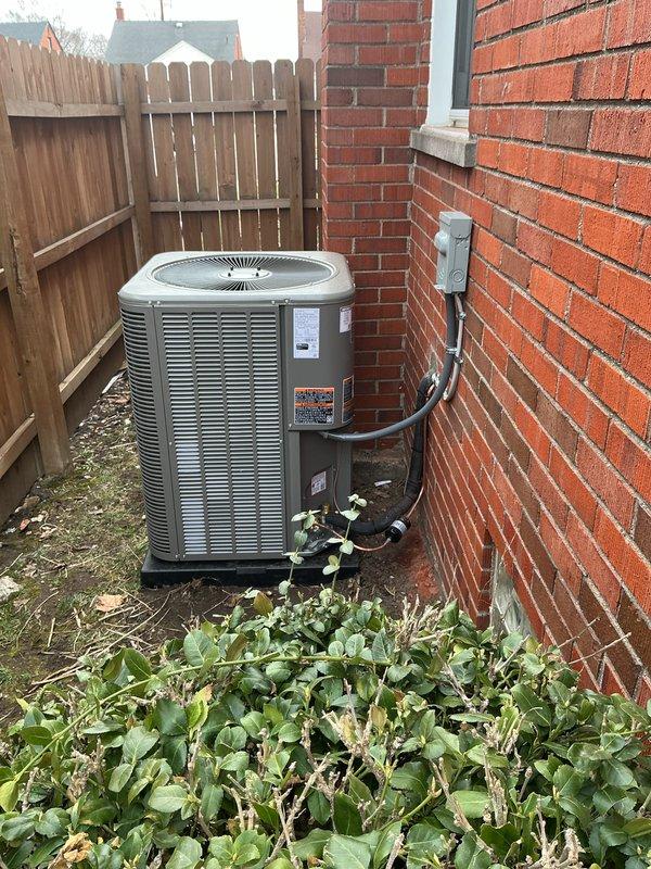 Completed installation of 2-ton air conditioning system with matching evaporator coil on left side return configuration. Installed outdoor condenser unit on concrete pad in side yard with refrigerant lines and electrical disconnect, connected indoor evaporator coil to existing Lennox furnace, and performed electrical and mechanical reconnection to ensure proper system operation.