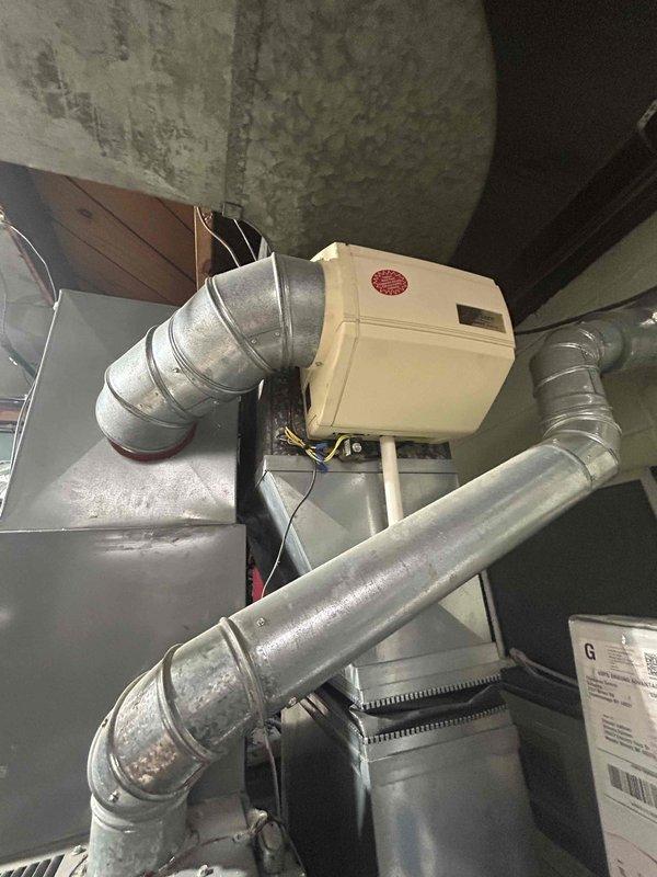 # HVAC Estimate - Replacement Summary

Completed comprehensive assessment for replacement of existing 15-year-old furnace and air conditioning system. Customer requested installation within next month timeframe. Evaluated current equipment condition and documented existing basement installation including humidifier integration and ductwork configuration. Photographed water heater clearances, existing HVAC components, furnace location, humidifier unit with connected metallic ductwork, and overall mechanical room layout to facilitate accurate replacement quote preparation. Provided detailed estimate for complete system replacement addressing both heating and cooling equipment that have reached end of expected service life.