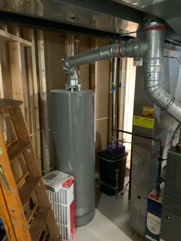 # HVAC Full System Estimate Report

Responded to service call for 16-year-old residential furnace system experiencing loud humming noise originating from the inducer motor. Performed comprehensive system evaluation to provide comparison between component replacement and complete system replacement options. 

Conducted thorough inspection of existing HVAC equipment located in unfinished basement utility area. Assessed furnace unit manufactured in 2005, documenting overall system condition, ductwork configuration, and installation environment. Evaluated inducer motor operation and identified source of abnormal humming noise consistent with bearing failure or motor degradation typical of units in this age range.

Documented existing system configuration including furnace unit, metallic ductwork with multiple elbows, and current venting arrangement. Photographed equipment layout, surrounding utility space, and mechanical connections to support estimate preparation. Noted exposed wooden fra