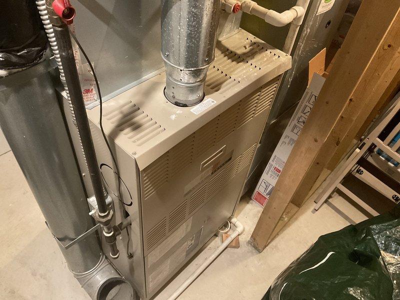 # HVAC Estimate - Replacement Summary

Conducted comprehensive evaluation of 22+ year-old residential natural gas furnace and air conditioning system located in basement. Current equipment operational but nearing end of service life. Documented existing installation including furnace unit, ductwork configuration, and associated water heater proximity. Photographed equipment model numbers and specifications, including unit identification G50 J-60D-135-04 and serial number 5R03G 20160. Assessed mechanical room layout, existing galvanized metal supply duct with visible condensation, PVC drainage and ventilation piping, and concrete floor installation conditions. Prepared detailed replacement estimate for complete furnace and air conditioning system upgrade to provide customer with equipment options and installation specifications for aging HVAC system replacement.