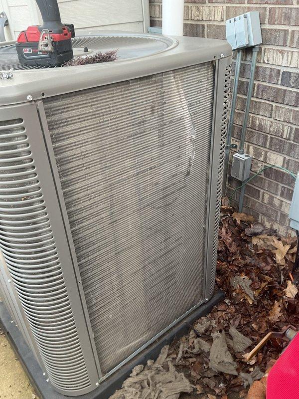 # ComfortGuard Maintenance - 5-Year Service Completion

Performed comprehensive annual maintenance service on residential split-system air conditioning unit. Conducted thorough inspection of outdoor condenser unit, which revealed significant accumulation of dirt, debris, and organic matter on condenser coils and surrounding areas. Removed access panels to expose internal components for detailed cleaning and assessment.

Cleaned heavily soiled condenser coils using appropriate methods to restore optimal heat transfer efficiency. The coils exhibited substantial buildup that would have significantly reduced system performance and energy efficiency if left unaddressed. Removed accumulated leaves, dirt, and debris from unit base, top surface, and surrounding pad area to prevent airflow restriction and potential drainage issues.

Verified electrical disconnect functionality and inspected all visible electrical connections and conduit for proper operation and safety compliance. Confirmed unit