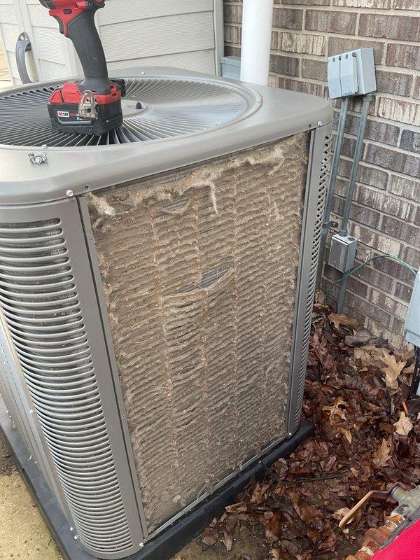 # ComfortGuard Maintenance - 5-Year Service Completion

Performed comprehensive annual maintenance service on residential split-system air conditioning unit. Conducted thorough inspection of outdoor condenser unit, which revealed significant accumulation of dirt, debris, and organic matter on condenser coils and surrounding areas. Removed access panels to expose internal components for detailed cleaning and assessment.

Cleaned heavily soiled condenser coils using appropriate methods to restore optimal heat transfer efficiency. The coils exhibited substantial buildup that would have significantly reduced system performance and energy efficiency if left unaddressed. Removed accumulated leaves, dirt, and debris from unit base, top surface, and surrounding pad area to prevent airflow restriction and potential drainage issues.

Verified electrical disconnect functionality and inspected all visible electrical connections and conduit for proper operation and safety compliance. Confirmed unit