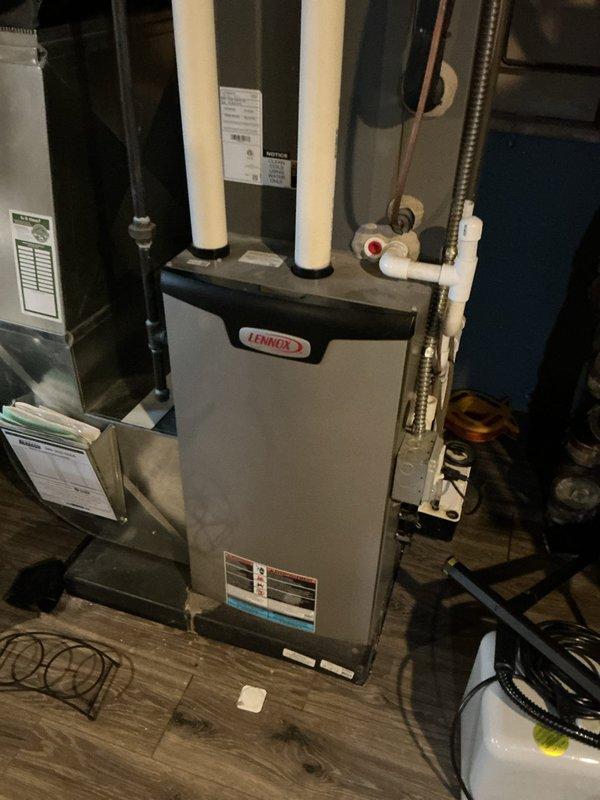 Completed comprehensive tune-up service on 6-year-old Lennox furnace system located in basement mechanical room. Performed full system inspection including thermostat calibration, humidifier functionality check, and hot water tank assessment. Inspected and documented air filter condition, verified proper venting through PVC intake/exhaust pipes, checked all electrical connections, and confirmed system is operating within manufacturer specifications with no immediate service needs identified.