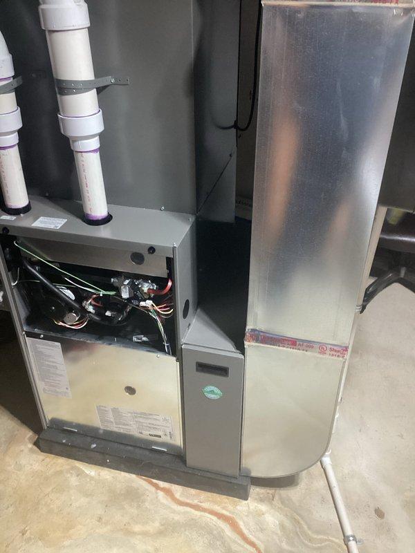 # HVAC Maintenance - AHM Service Report

Completed annual heating maintenance on residential furnace system as part of customer's maintenance membership plan. Performed comprehensive tune-up inspection with furnace access panel removed to assess all internal components including blower motor assembly, electrical connections, wiring harnesses, circuit boards, and mechanical systems. Verified proper operation of all safety controls and electrical circuits throughout the unit.

Conducted standard preventive maintenance procedures on the heating system. Inspected ductwork connections and air handler plenum for proper installation and secure fittings. Examined PVC venting system including condensate drain lines, noting proper installation with visible primer markings at joints indicating code-compliant assembly. 

Performed routine maintenance tasks including inspection of blower motor components and verification of all wire connections and harnesses for secure attachment and proper routing