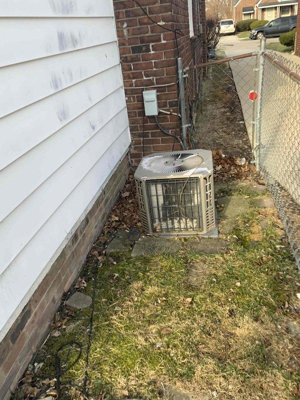 Completed full system estimate for residential HVAC replacement. Evaluated existing 16-year-old furnace and air conditioning system with customer requesting immediate replacement. Documented exterior condensing unit showing significant age-related wear and deterioration, photographed equipment location in side yard service area between buildings, and assessed installation requirements including electrical disconnect and clearance specifications for new system installation.