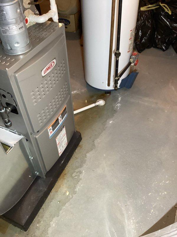 # HVAC Service - Furnace

Responded to no heat call on 3-year-old Lennox furnace unit. Upon arrival, discovered significant water accumulation on basement floor surrounding furnace and water heater, indicating active leak from water heater affecting HVAC equipment operation. Diagnosed water heater failure as root cause of furnace malfunction due to water intrusion compromising electrical components and safety controls. Documented conditions with photographs showing extent of water damage and equipment affected. Advised customer of water heater replacement necessity and recommended addressing water damage to prevent further HVAC system complications. Unit remains under parts and labor warranty; no diagnostic charges applied per warranty coverage.