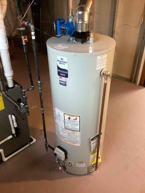 Installed a 50-gallon Bradford White tanked water heater in basement utility area with proper venting through existing ductwork system. Connected all supply and discharge plumbing lines, installed safety valves, and integrated unit with existing circulation pump system. Permits were obtained prior to installation, and all work was completed to code specifications.