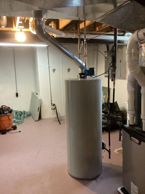 Installed a 50-gallon Bradford White tanked water heater in basement utility area with proper venting through existing ductwork system. Connected all supply and discharge plumbing lines, installed safety valves, and integrated unit with existing circulation pump system. Permits were obtained prior to installation, and all work was completed to code specifications.