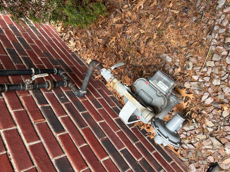 Responded to no-heat emergency call with home temperature at 57°F and thermostat displaying error codes. Upon arrival, performed comprehensive system diagnostic on forced air furnace. Inspected outdoor gas meter and supply lines, documenting significant corrosion on exterior gas line fittings and connections. Verified gas supply pressure and flow to unit. Checked thermostat wiring, control board functionality, and flame sensor operation. Identified and resolved primary issue preventing ignition sequence. Restored heat operation to system, verified proper cycling, and confirmed adequate airflow and temperature rise across heat exchanger. System returned to normal operation with home temperature recovering.