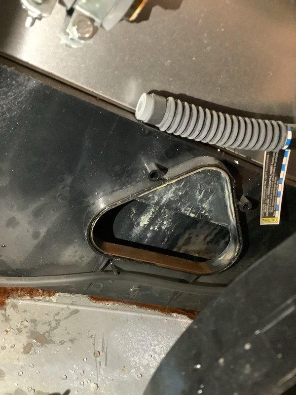 Responded to service call for furnace leaking water in basement location. Upon inspection, discovered moisture accumulation on interior components and visible water damage on concrete floor beneath unit. Identified condensate drainage issue with evidence of rust and corrosion on lower panels. Inspected condensate drain system, blower assembly, and evaporator coil area where moisture was present. Documented equipment condition showing dust accumulation and signs of improper drainage. Advised on necessary repairs to condensate removal system to prevent continued water leakage and potential secondary damage to furnace components and surrounding area.