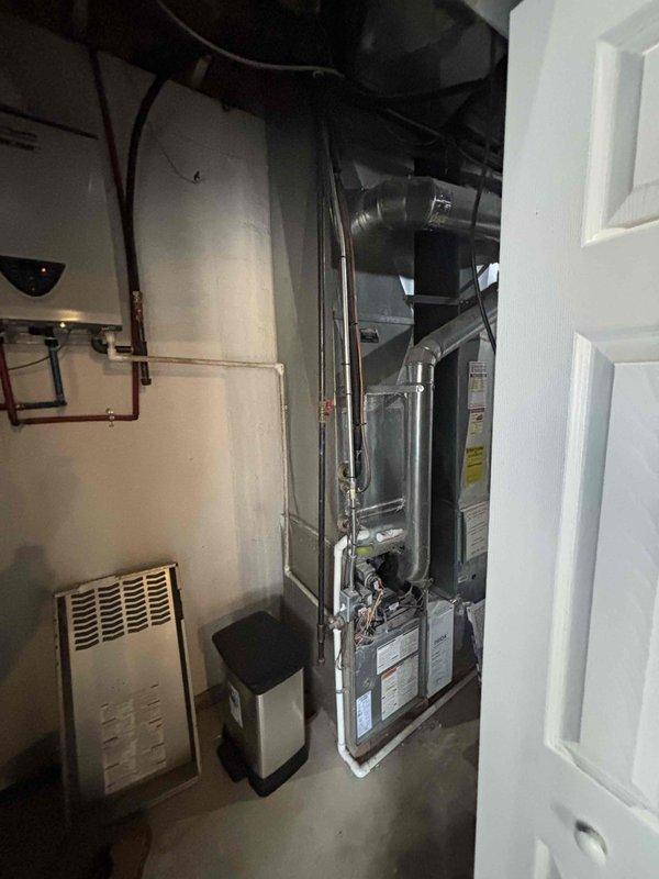 Provided comprehensive estimate for replacement of 20+ year old furnace and air conditioning system located in basement mechanical room as part of promotional offer. Existing natural gas furnace and AC unit currently operational but nearing end of service life. Assessment included evaluation of existing ductwork, electrical connections, condensate drainage, and venting requirements for proper sizing and installation planning of new high-efficiency HVAC system.