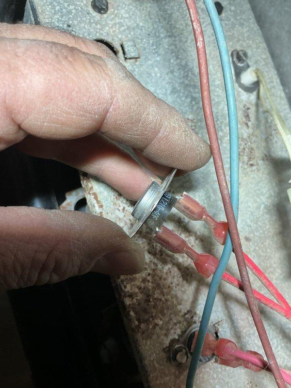 Replaced defective thermal limit switch on HVAC unit. Disconnected existing wiring, removed failed safety device from mounting panel, installed new thermal fuse with proper wire terminations using crimp connectors, and secured component to galvanized panel. Verified all electrical connections were tight and system restored to safe operating condition.