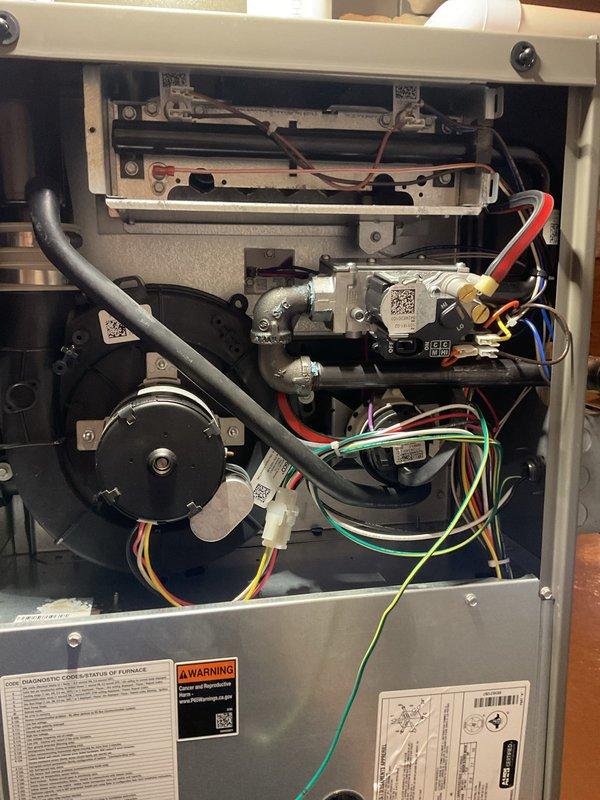 # Annual Heating Maintenance Completed

Performed comprehensive annual maintenance on residential gas furnace system under air care membership coverage. Conducted complete system inspection with access panels removed to evaluate all internal components, mechanical assemblies, and electrical connections.

Inspected gas valve assembly, burner components, and flame sensor for proper operation and cleanliness. Verified all electrical connections including control wiring harnesses with multiple conductor pathways throughout unit. Examined inducer motor assembly and blower motor for proper mechanical function and secure mounting.

Evaluated heat exchanger condition and integrity, checking for signs of stress, corrosion, or potential failure points. Inspected all gas connections, fittings, and brass components for leaks and proper sealing. Verified condensate drainage system components and flexible hose connections.

Reviewed all factory labels, diagnostic information, and safety warning plac