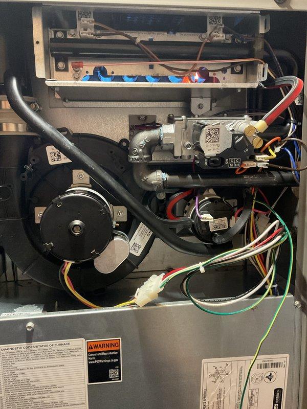 # Annual Heating Maintenance Completed

Performed comprehensive annual maintenance on residential gas furnace system under air care membership coverage. Conducted complete system inspection with access panels removed to evaluate all internal components, mechanical assemblies, and electrical connections.

Inspected gas valve assembly, burner components, and flame sensor for proper operation and cleanliness. Verified all electrical connections including control wiring harnesses with multiple conductor pathways throughout unit. Examined inducer motor assembly and blower motor for proper mechanical function and secure mounting.

Evaluated heat exchanger condition and integrity, checking for signs of stress, corrosion, or potential failure points. Inspected all gas connections, fittings, and brass components for leaks and proper sealing. Verified condensate drainage system components and flexible hose connections.

Reviewed all factory labels, diagnostic information, and safety warning plac