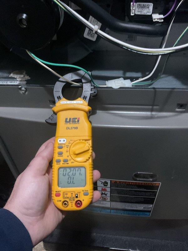 Completed annual furnace maintenance and tune-up on residential HVAC system. Performed comprehensive electrical diagnostics using digital clamp meter, recording amperage readings of 42.04A and 0.949A on system components to verify proper operation. Inspected all wiring connections, confirmed secure wire bundling with proper cable management, and verified all electrical components within manufacturer specifications. System tested and operating normally with no issues identified.