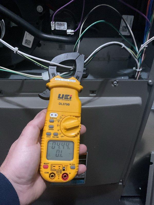 Completed annual furnace maintenance and tune-up on residential HVAC system. Performed comprehensive electrical diagnostics using digital clamp meter, recording amperage readings of 42.04A and 0.949A on system components to verify proper operation. Inspected all wiring connections, confirmed secure wire bundling with proper cable management, and verified all electrical components within manufacturer specifications. System tested and operating normally with no issues identified.