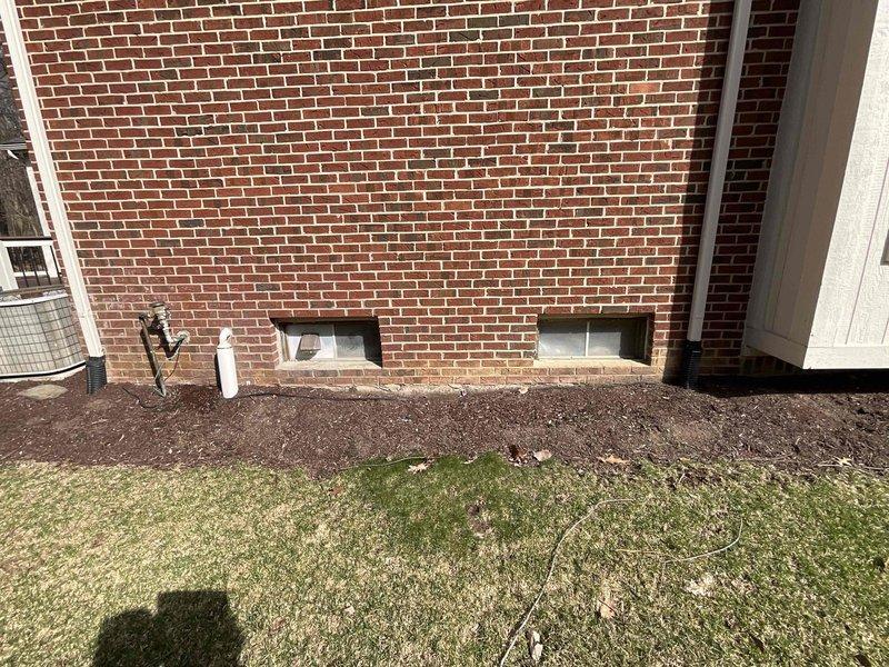 Completed comprehensive assessment and provided replacement estimate for 30-year-old residential HVAC system including both furnace and air conditioning unit. Inspected existing beige sheet metal furnace cabinet located in basement utility area with connected ductwork, plenum transitions, and flexible duct runs, as well as exterior condensing unit positioned at foundation level near crawl space vents. Documented current system configuration, ductwork connections, copper refrigerant lines, and equipment accessibility for replacement planning within requested 30-day timeframe.