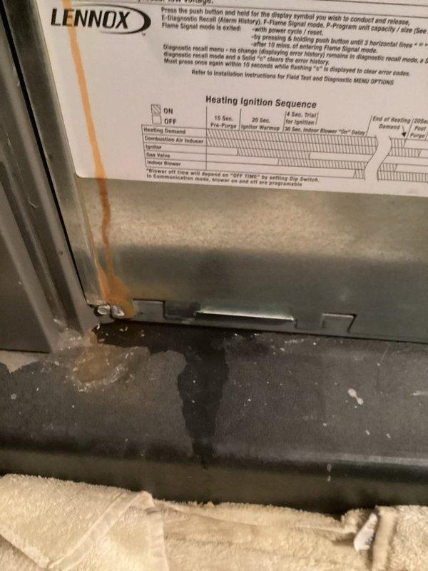 # HVAC Service - Furnace

Responded to service call for water leakage on 5-year-old furnace unit located in basement. Upon arrival, found significant water pooling beneath Lennox furnace with visible rust staining on interior metal panels, indicating ongoing moisture intrusion. Performed diagnostic inspection to identify source of leak.

Inspected condensate drainage system including primary drain line, secondary drain pan, and associated plumbing connections. Examined evaporator coil assembly and condensate collection system for blockages or failures. Checked furnace heat exchanger for cracks or compromised integrity that could contribute to moisture issues. Evaluated flue pipe and venting system for proper pitch and potential condensation backup.

Observed water accumulation on lower platform of unit and towels placed to absorb leaking water. Documented rust damage on interior panel surfaces caused by prolonged moisture exposure. Traced water source through systematic component inspe