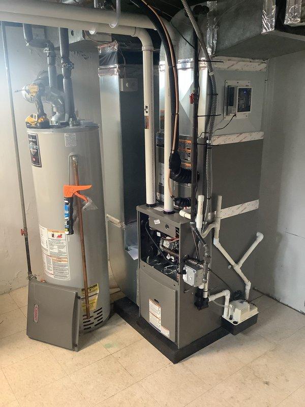 Completed full HVAC system installation including a 70,000 BTU furnace and 2-ton air conditioning unit with rear discharge configuration. Installed new condensate drainage system using PVC piping, connected refrigerant lines, ran electrical conduit to panel, and integrated whole-home humidifier into the system. Secured all required mechanical and electrical permits prior to installation, mounted furnace on platform base in basement utility area, sealed all ductwork connections, and reconnected existing equipment to ensure proper system operation.