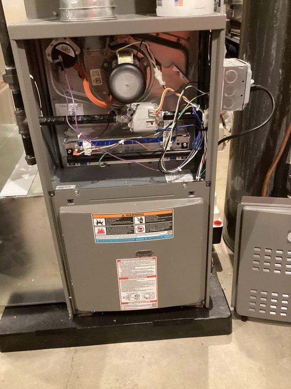 Completed annual furnace maintenance and tune-up on residential gas forced-air heating system. Performed comprehensive inspection of all internal components including blower motor, electrical connections, control boards, and safety systems. Verified proper electrical operation using digital multimeter, confirming voltage readings within manufacturer specifications at 5.19V on tested circuit. All wiring connections secure, system operating safely and efficiently with no deficiencies noted.
