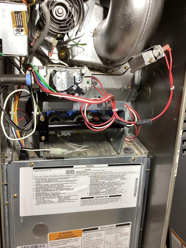 Responded to service call for furnace cycling on and off intermittently in basement installation. Performed diagnostic inspection of gas furnace system including visual examination of blower assembly, gas valve, control module, and electrical connections. Inspected all wiring harnesses and safety controls for proper operation and secure connections. Evaluated air filter condition and verified adequate airflow through system. Documented equipment configuration and current operating conditions with photographic records of internal components and filtration system.