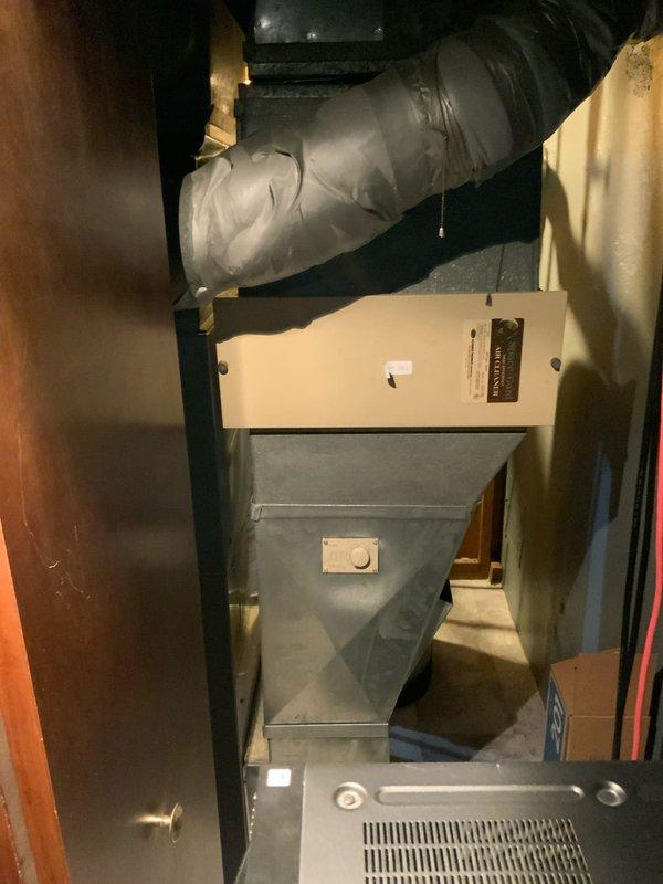 Conducted comprehensive evaluation of 24-year-old non-operational natural gas furnace and air conditioning system located in basement. Assessed existing gray metal furnace unit with flexible ductwork installation, evaluated electrical panel configuration and circuit capacity for HVAC system requirements. Documented current equipment condition through photographic inspection showing furnace with insulated ductwork connections and residential breaker panel arrangement. Prepared replacement estimates for complete furnace and air conditioning system, as well as furnace-only replacement option based on equipment age, operational failure, and system configuration requirements.