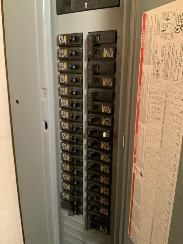 Conducted comprehensive evaluation of 24-year-old non-operational natural gas furnace and air conditioning system located in basement. Assessed existing gray metal furnace unit with flexible ductwork installation, evaluated electrical panel configuration and circuit capacity for HVAC system requirements. Documented current equipment condition through photographic inspection showing furnace with insulated ductwork connections and residential breaker panel arrangement. Prepared replacement estimates for complete furnace and air conditioning system, as well as furnace-only replacement option based on equipment age, operational failure, and system configuration requirements.