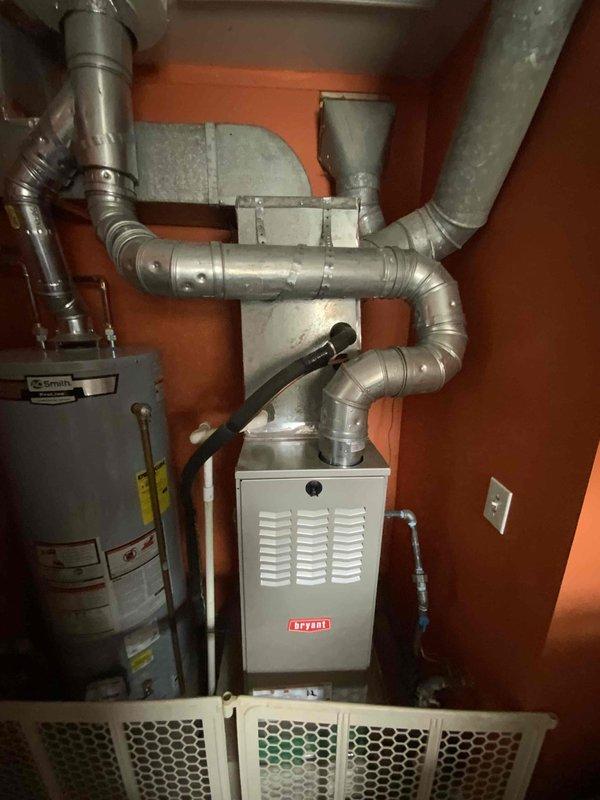 Conducted on-site evaluation of residential HVAC system for new homeowners following report of burned-out air conditioning unit from previous owner. Inspected 15-year-old AC system and existing Bryant furnace installation located in utility closet with A.O. Smith water heater. Assessed ductwork configuration, equipment condition, and system compatibility for replacement recommendations. Documented existing mechanical room layout and equipment specifications through photographic records to prepare comprehensive replacement estimate for complete AC system installation.