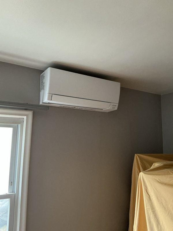 Successfully installed a ductless mini-split air conditioning system with indoor wall-mounted unit positioned high on the interior wall near the ceiling. Installation included mechanical and electrical work with new dedicated circuit to support the system. All necessary permits were obtained prior to installation, and the unit was mounted securely in accordance with manufacturer specifications and local code requirements.