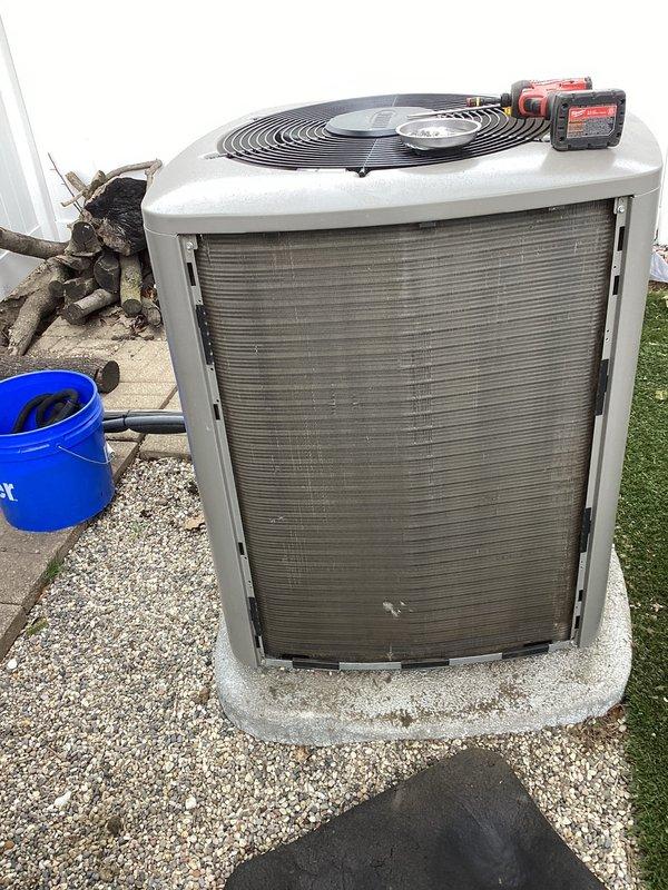 # HVAC Maintenance - ACM Completed

Performed routine air conditioning maintenance on residential split system outdoor condensing unit. Upon arrival, conducted visual inspection of equipment exterior and surrounding area. Opened access panel to evaluate air filter condition and discovered heavily contaminated flat panel filter with significant dust and debris accumulation throughout surface area. Filter exhibited gray-brown discoloration with uneven distribution patterns and material clumping, indicating extended service interval.

Removed and replaced soiled air filter with new filter media to restore proper airflow and system efficiency. Inspected condenser coil fins for damage, debris, and airflow obstruction. Verified fan blade assembly operation and checked for proper rotation. Examined unit mounting on concrete pad for levelness and stability. Assessed gravel and soil drainage around equipment base to ensure adequate water runoff and prevent standing water issues.

Documented equ