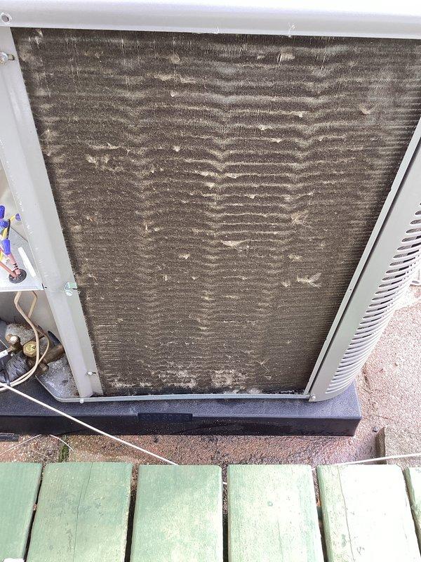 Performed routine air conditioning maintenance on outdoor condensing unit. Inspected heavily soiled condenser coils and air filter showing significant dirt and debris accumulation, assessed refrigerant lines and electrical components, and documented unit condition requiring cleaning to maintain optimal system efficiency.